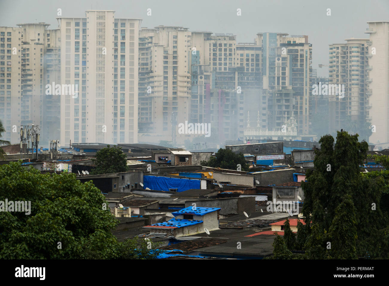 Slum area housing and contrasting middle class apartment blocks in Chandivali, Mumbai, India Stock Photo