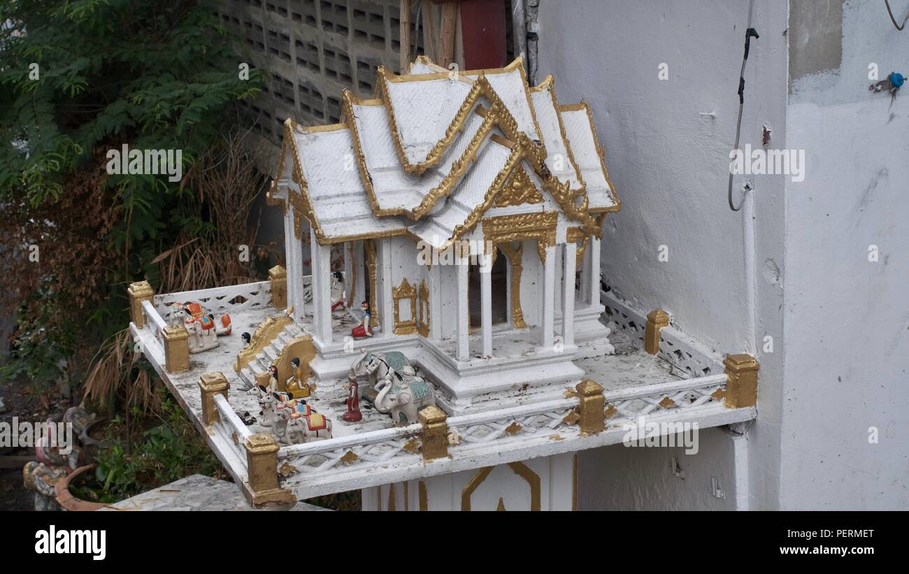 Buddha Shrine for Business White Temple House offer protection and good luck Chokh dī Thai culture Thai spirit house folklore Temple of Understanding Stock Photo