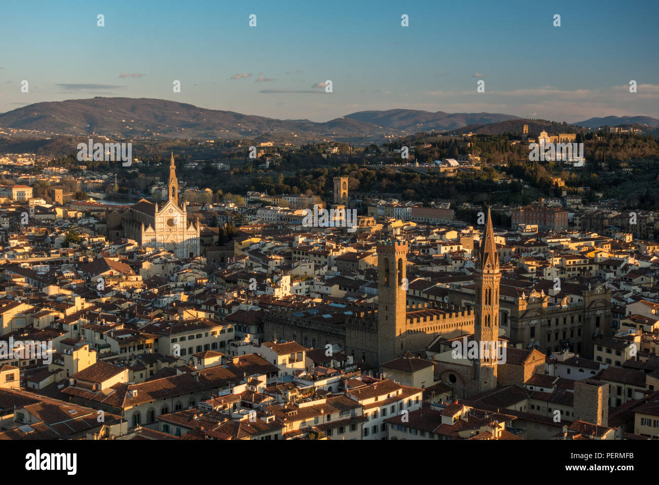 Florence, Italy - March 23, 2018: Evening light illuminates the cityscape of Florence, including the Bargello Tower and Basilica di Santa Croce church Stock Photo