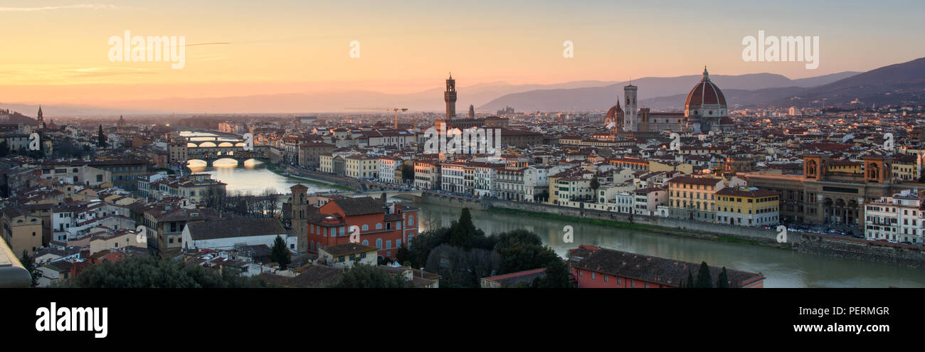 Florence, Italy - March 22, 2018: Afternoon sun illuminates the cityscape of Florence, including the landmark Duomo Cathedral and Ponte Vecchio bridge Stock Photo