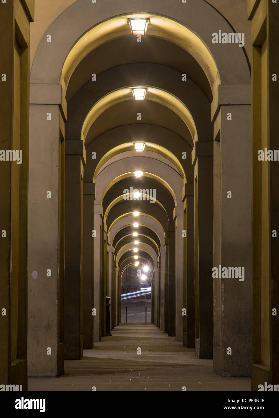 Florence, Italy - March 21, 2018: The Renaissance Vasari Corridor is lit at night in Florence. Stock Photo