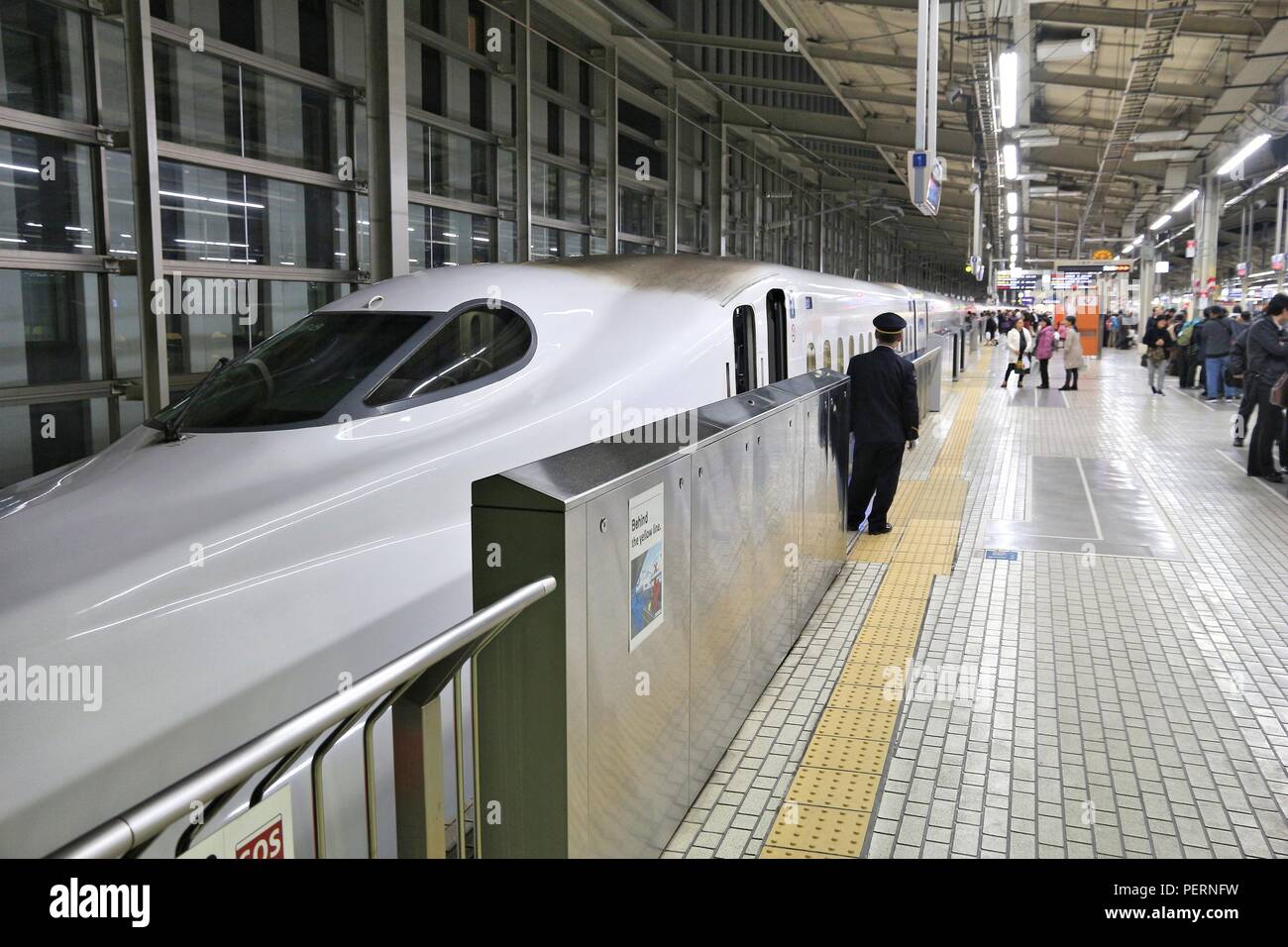 KYOTO, JAPAN - NOVEMBER 28, 2016: Passengers board Shinkansen train in Kyoto Station, Japan. Shinkansen bullet trains are operated by five Japan Railw Stock Photo