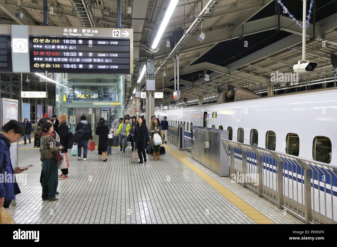 KYOTO, JAPAN - NOVEMBER 28, 2016: Passengers board Shinkansen train in Kyoto Station, Japan. Shinkansen bullet trains are operated by five Japan Railw Stock Photo