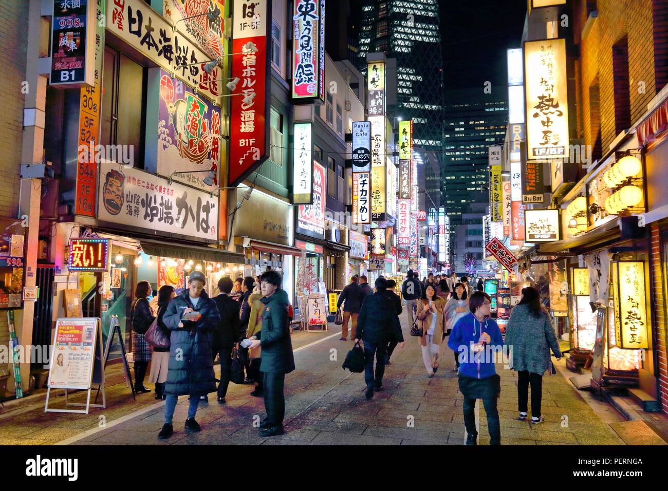 TOKYO, JAPAN - DECEMBER 2, 2016: People visit restaurants of Shinjuku district of Tokyo, Japan. Tokyo is the capital city of Japan. 37.8 million peopl Stock Photo