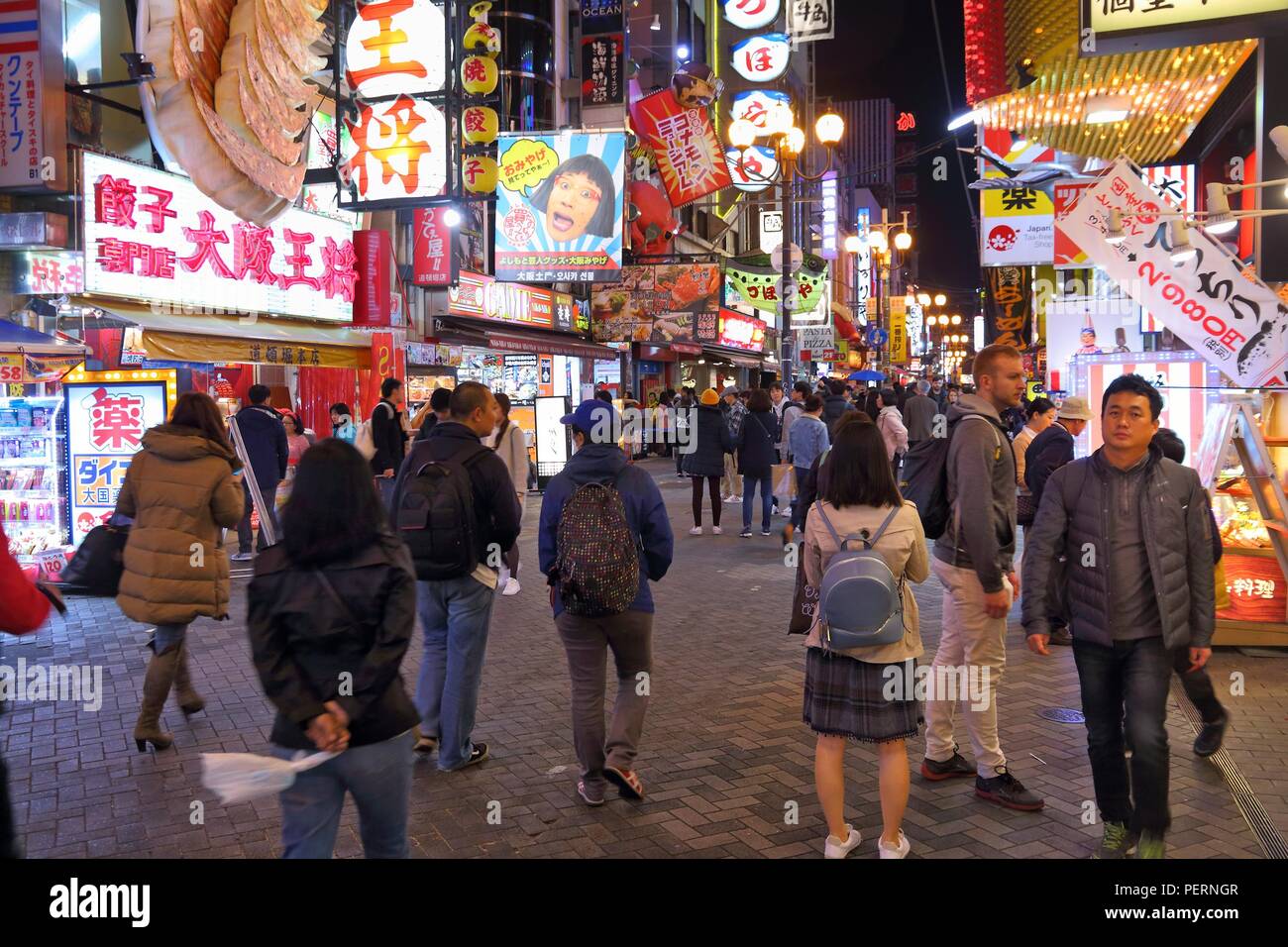 OSAKA, JAPAN - NOVEMBER 21, 2016: People visit night Dotonbori street in Osaka, Japan. Dotonbori is the main entertainment area of Osaka. Stock Photo