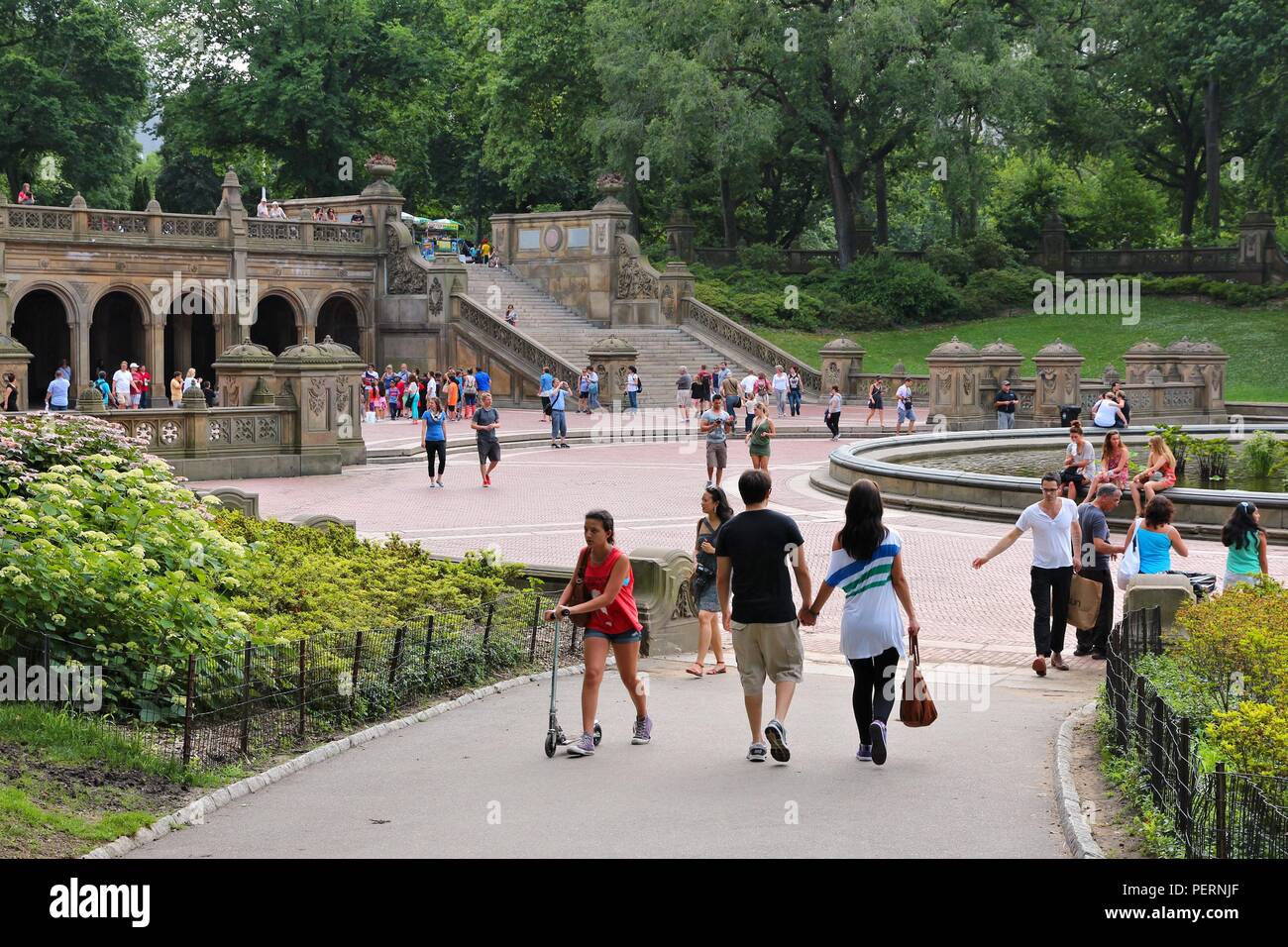 NEW YORK - JULY 3: People visit Central Park on July 3, 2013 in New York. Park opened in 1857 and covers 840 acres of land today. Stock Photo