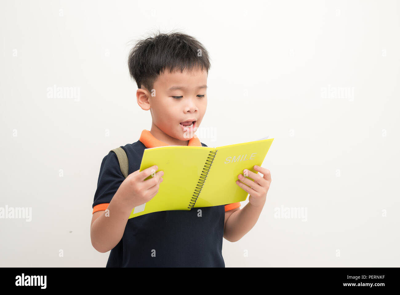 Happy little boy with book isolated on white background Stock Photo - Alamy