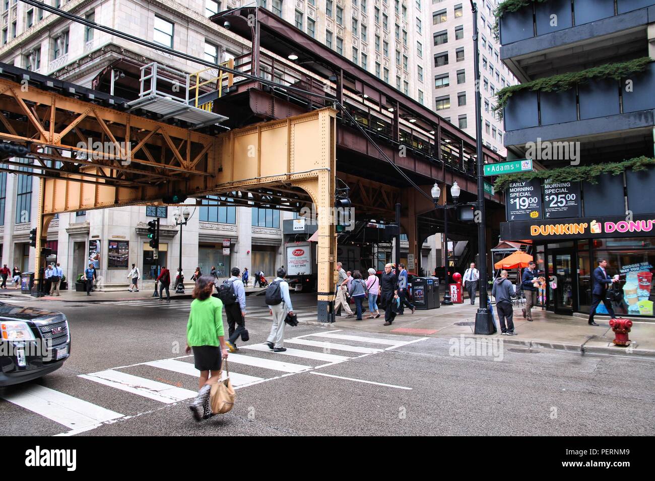 CHICAGO, USA - JUNE 26, 2013: People walk downtown in Chicago. Chicago is the 3rd most populous US city with 2.7 million residents (8.7 million in its Stock Photo