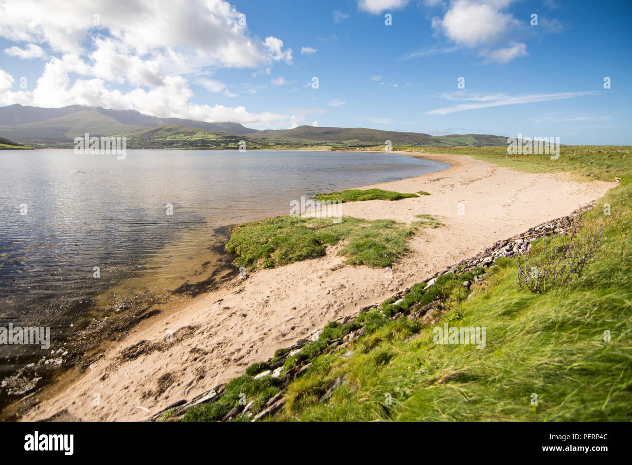 The sandy shores of the Cloghane Estuary beside Brandon Bay on the Dingle Peninsula, with Brandon Mountain rising behind, in the west of Ireland's Cou Stock Photo