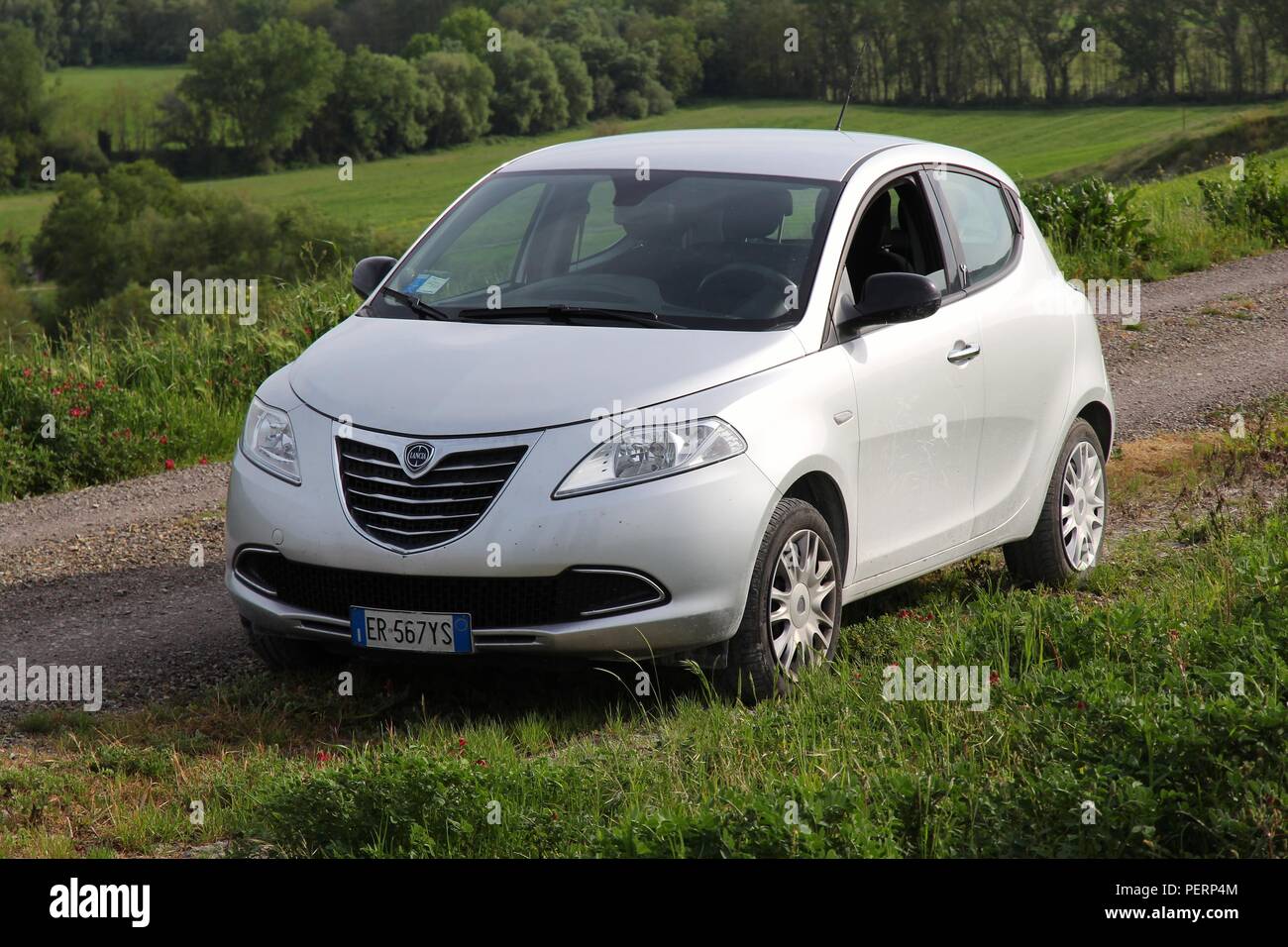 SIENA, ITALY - MAY 3, 2015: Lancia Ypsilon small hatchback car parked in  Siena countryside, Italy. Lancia is part of Fiat Chrysler Automobiles, 7th  la Stock Photo - Alamy