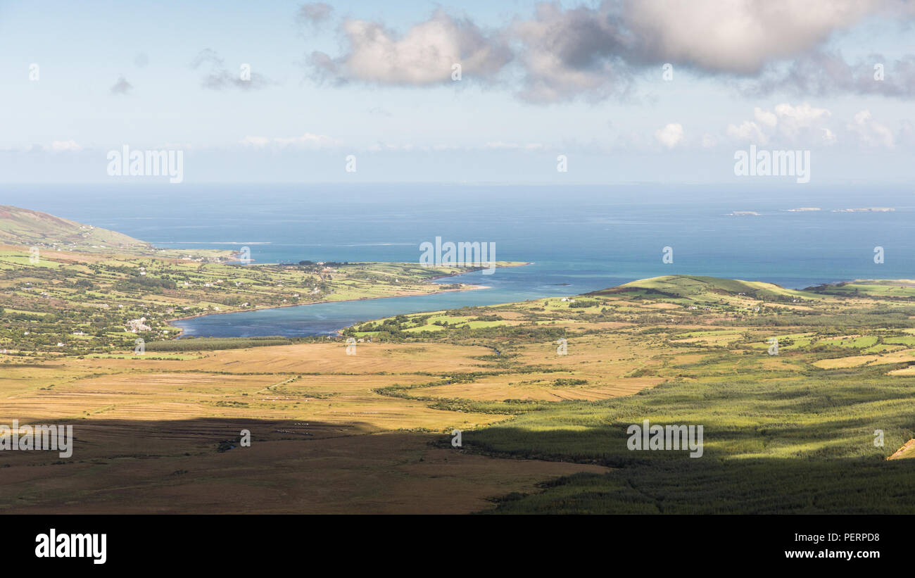 Rivers flowing from the mountains of Ireland's Dingle Peninsula flow through the Owenmore Valley into the Cloghane Estuary and Tralee Bay, as viewed f Stock Photo