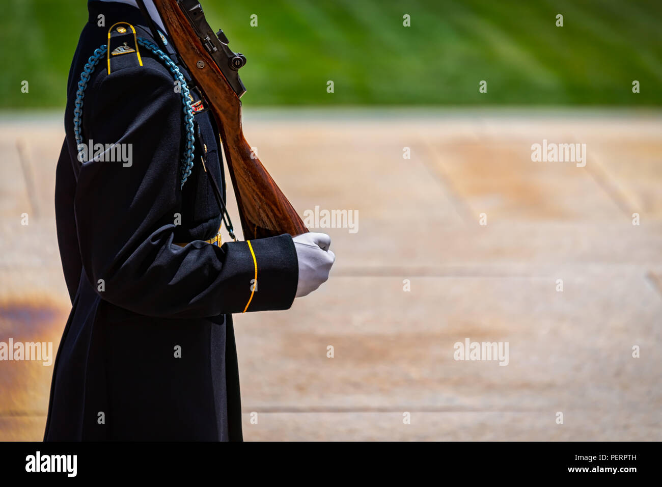An Army soldier, in white gloves, carrying his weapon on guard duty. Stock Photo