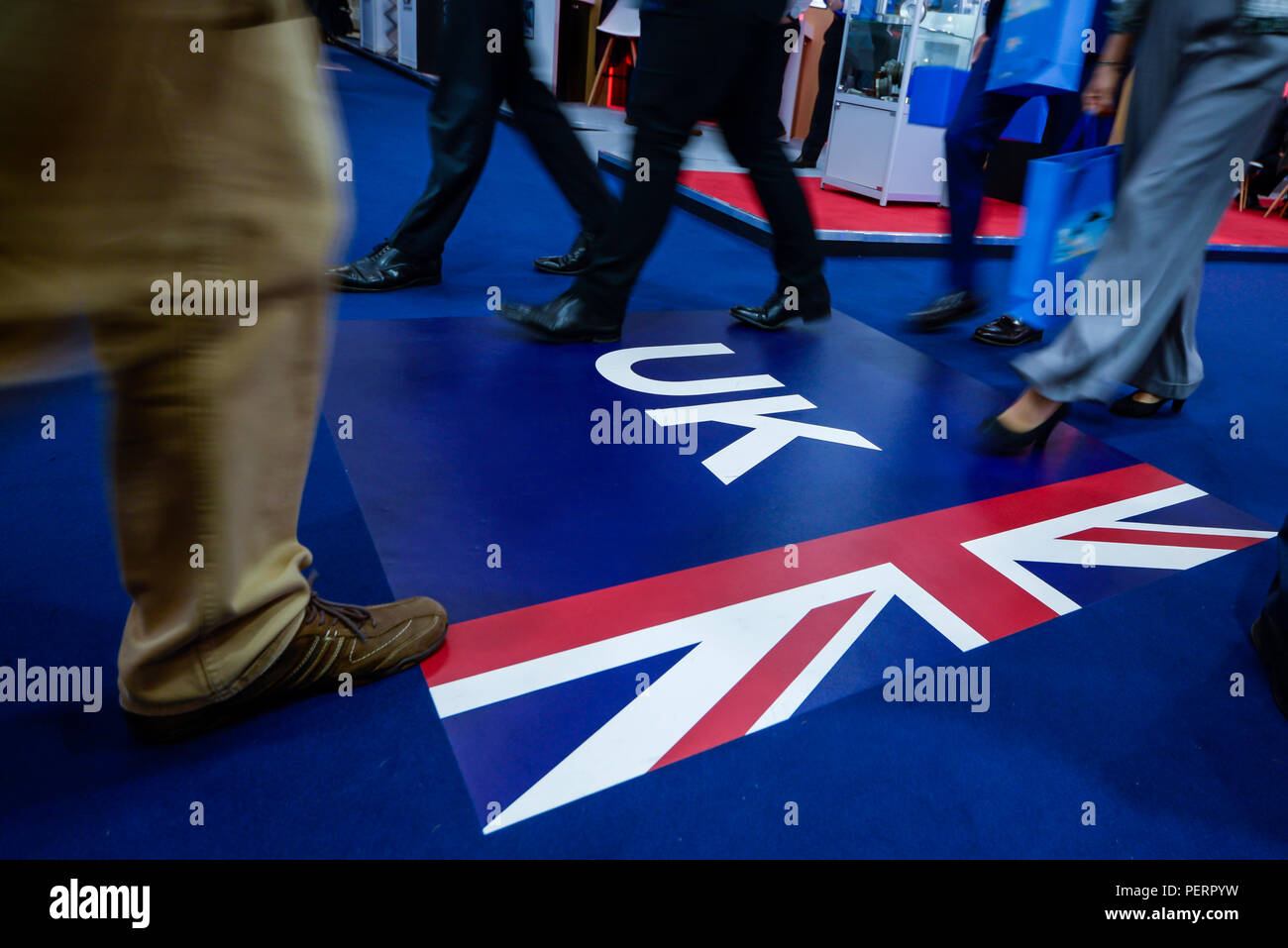 Walking over the UK. United Kingdom British Union Jack Flag on the floor being walked over in the display halls at Farnborough International Airshow Stock Photo