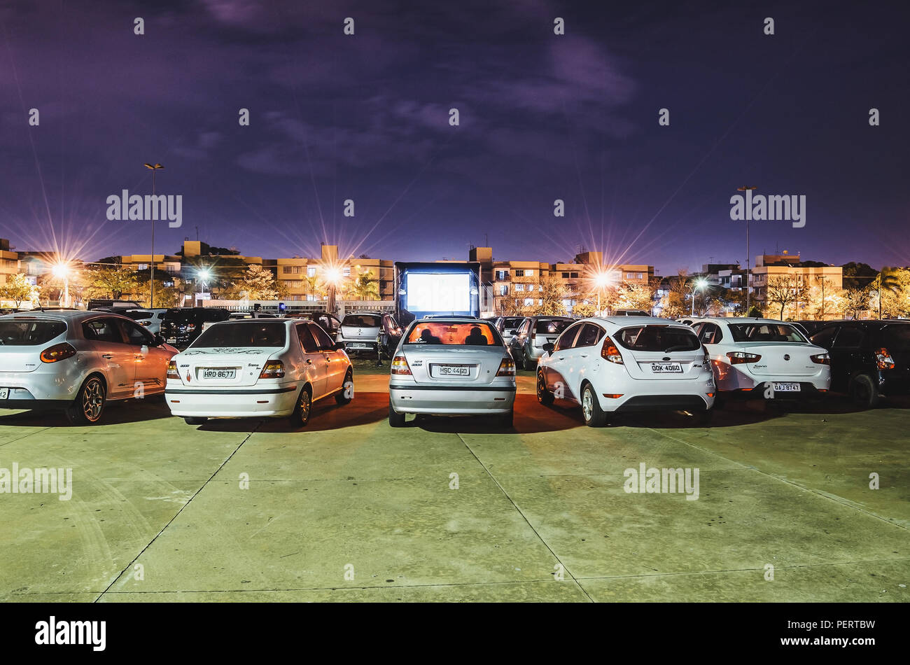 Campo Grande, Brazil - August 16, 2018: Parked cars at Praca do Papa square to watch movies inside the car. Cine Autorama event, drive-in, open air ci Stock Photo