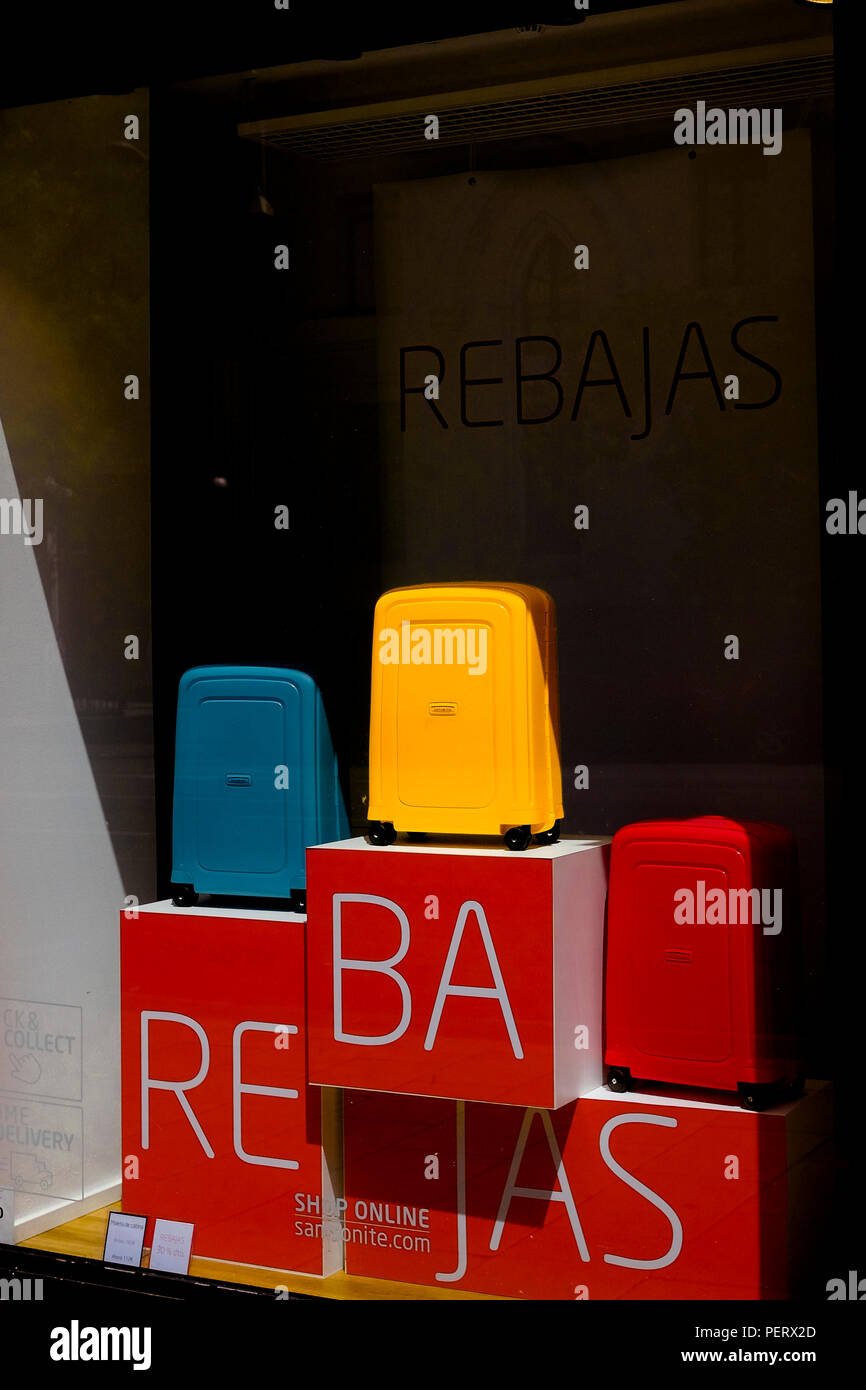 A Samsonite bright yellow suitcase on sale (rebajas) in the fashion distric of Serrano in Madrid, Spain. Stock Photo