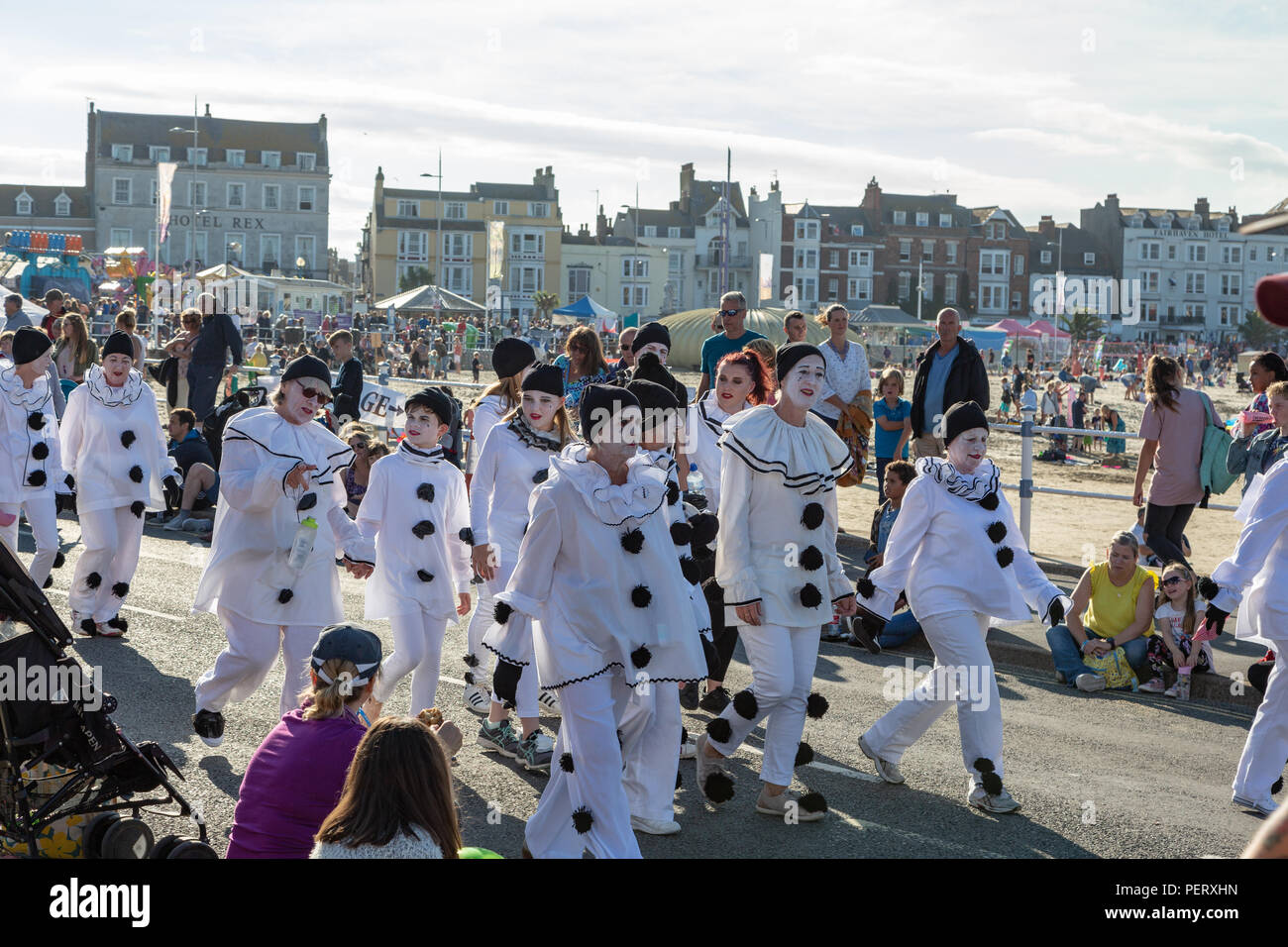 Crowds flock to watch the Weymouth carnival, on a beautiful warm