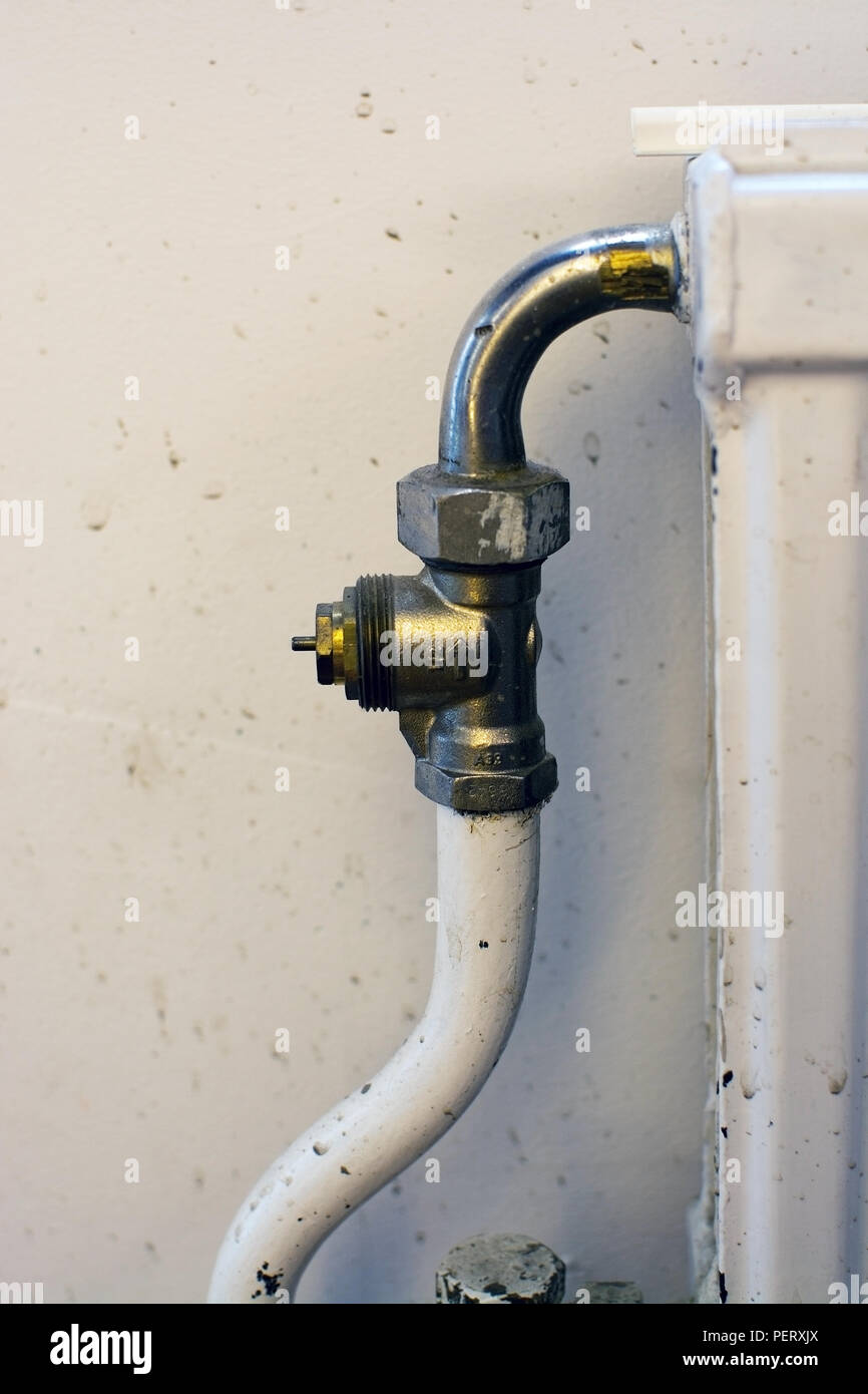 Metal plumbing water connector to radiator indoors Stock Photo - Alamy