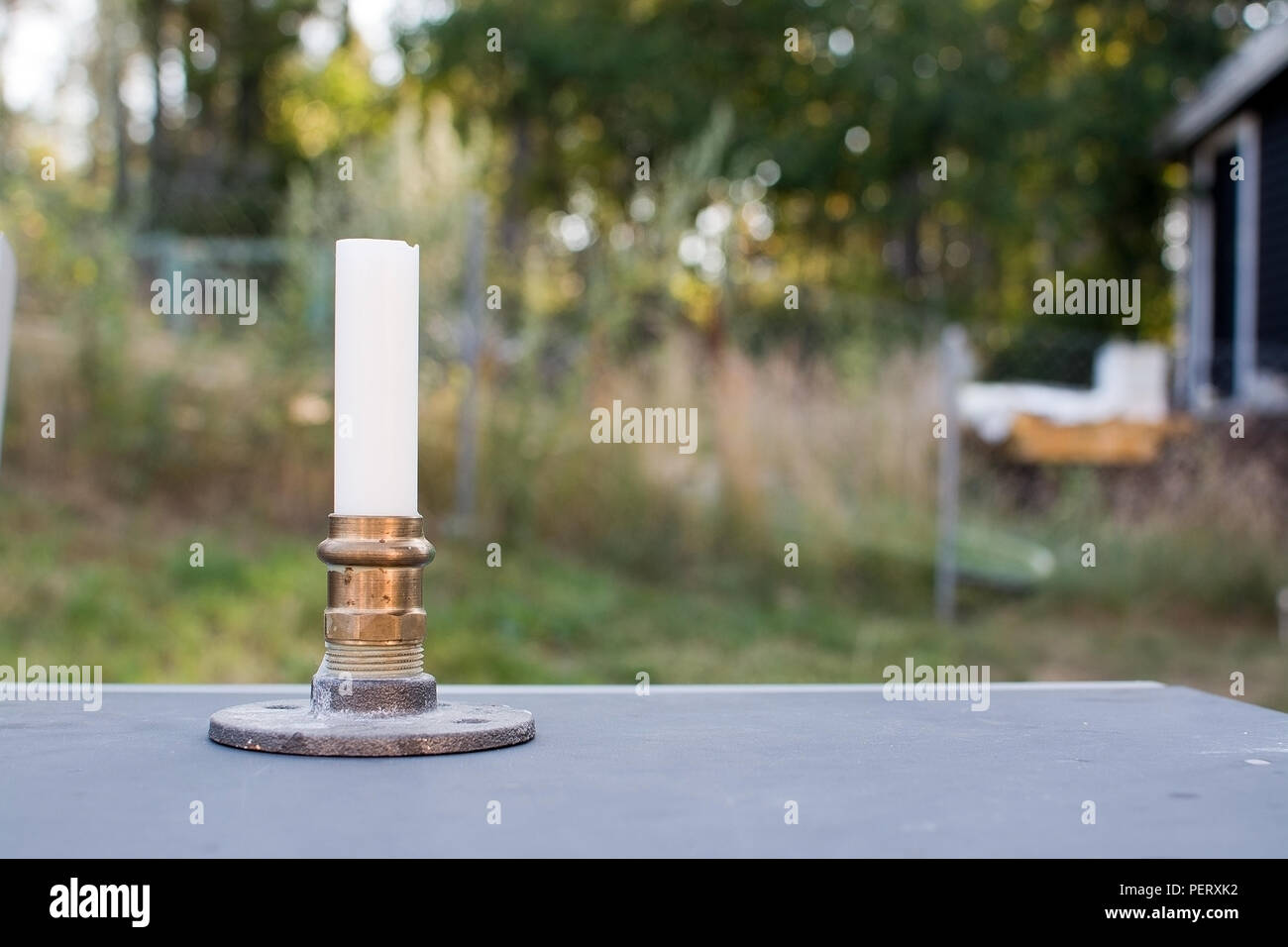 Plumbers homemade candle holder made of copper nuts and other plumbing parts Stock Photo