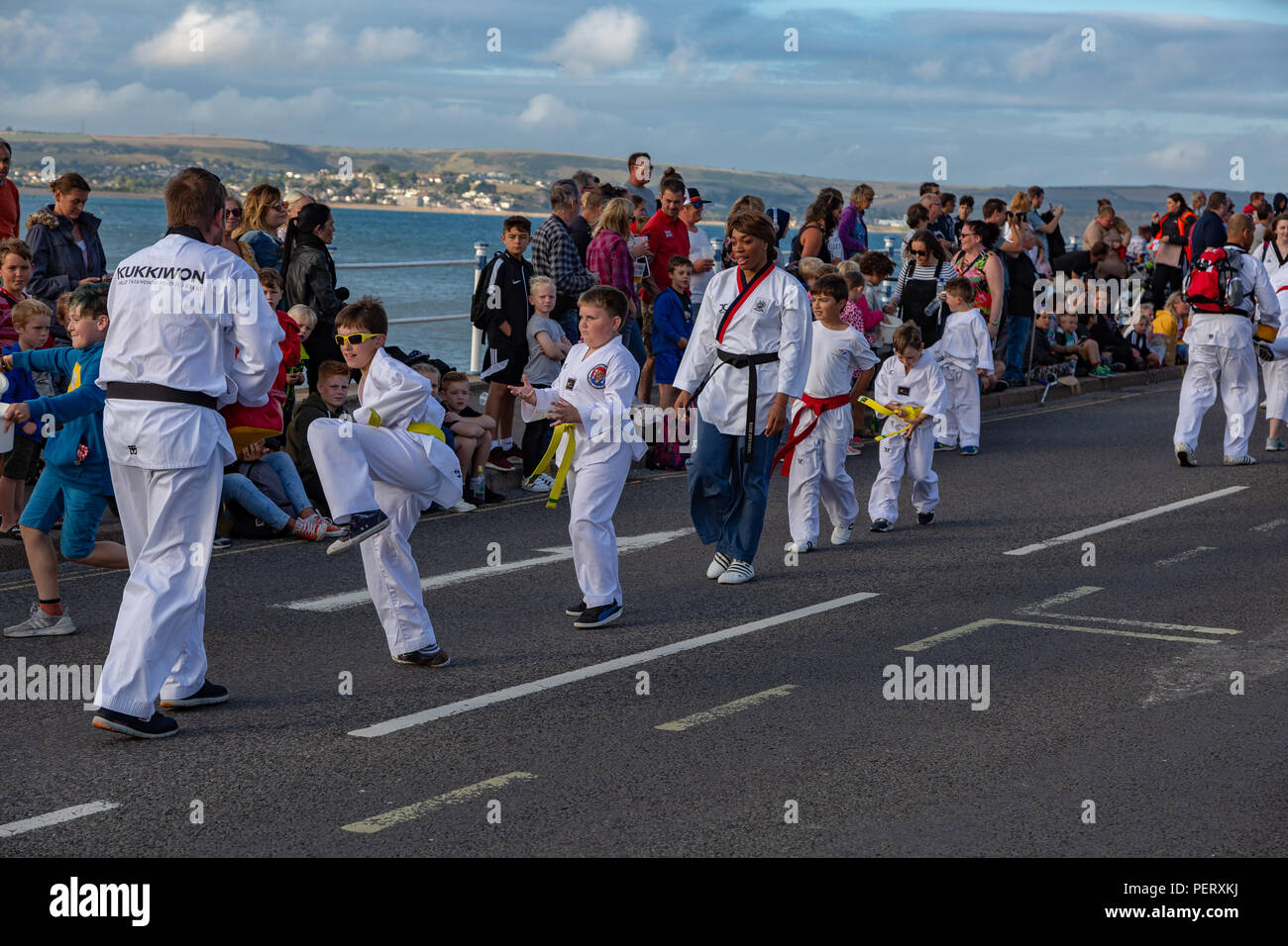 Crowds flock to watch the Weymouth carnival, on a beautiful warm
