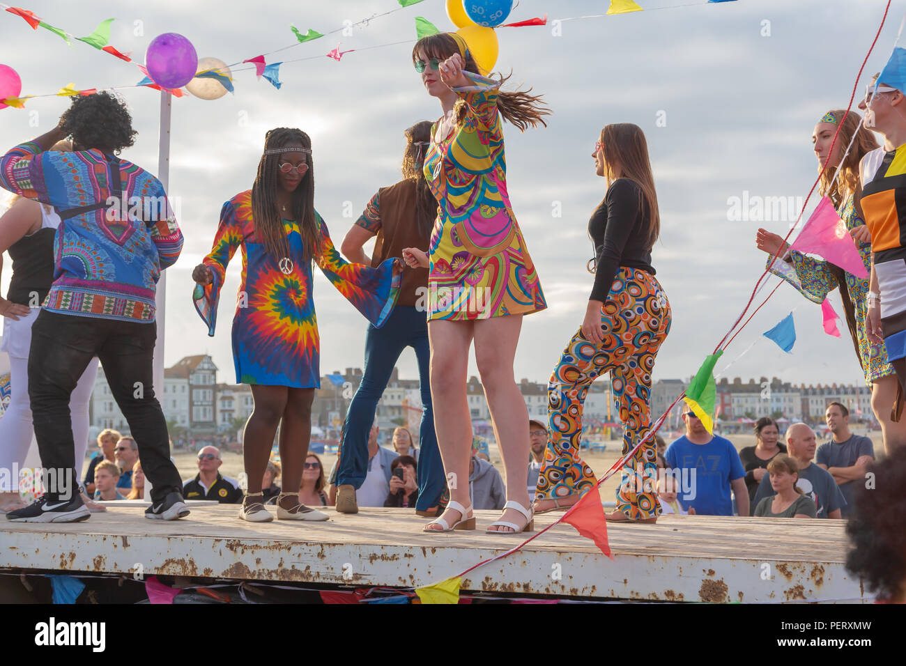 Crowds flock to watch the Weymouth carnival, on a beautiful warm