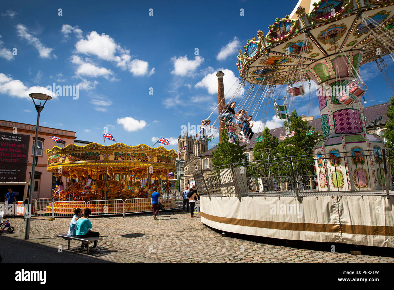 England, Bristol, Millennium Square, children enjoying  traditonal funfair rides Stock Photo