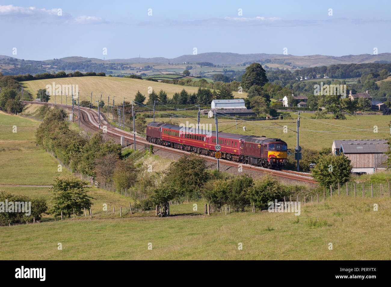 A West coast Railways class 33 locomotive on the west coast main line with empty carriages that had been running the windermere branch line trains Stock Photo