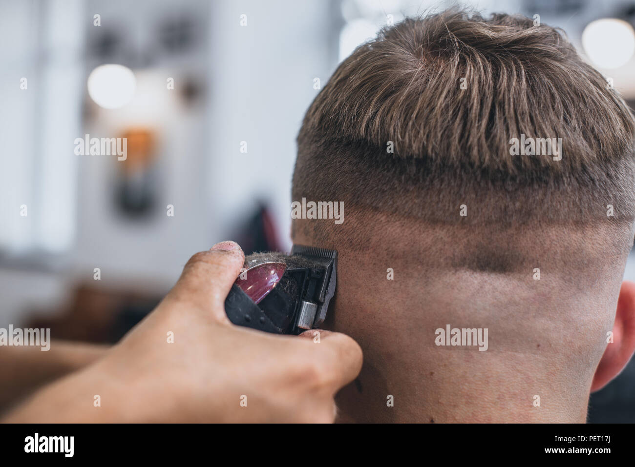 Haircut men Barbershop. Men's Hairdressers barbers. Barber cuts the client machine for haircuts. Stock Photo