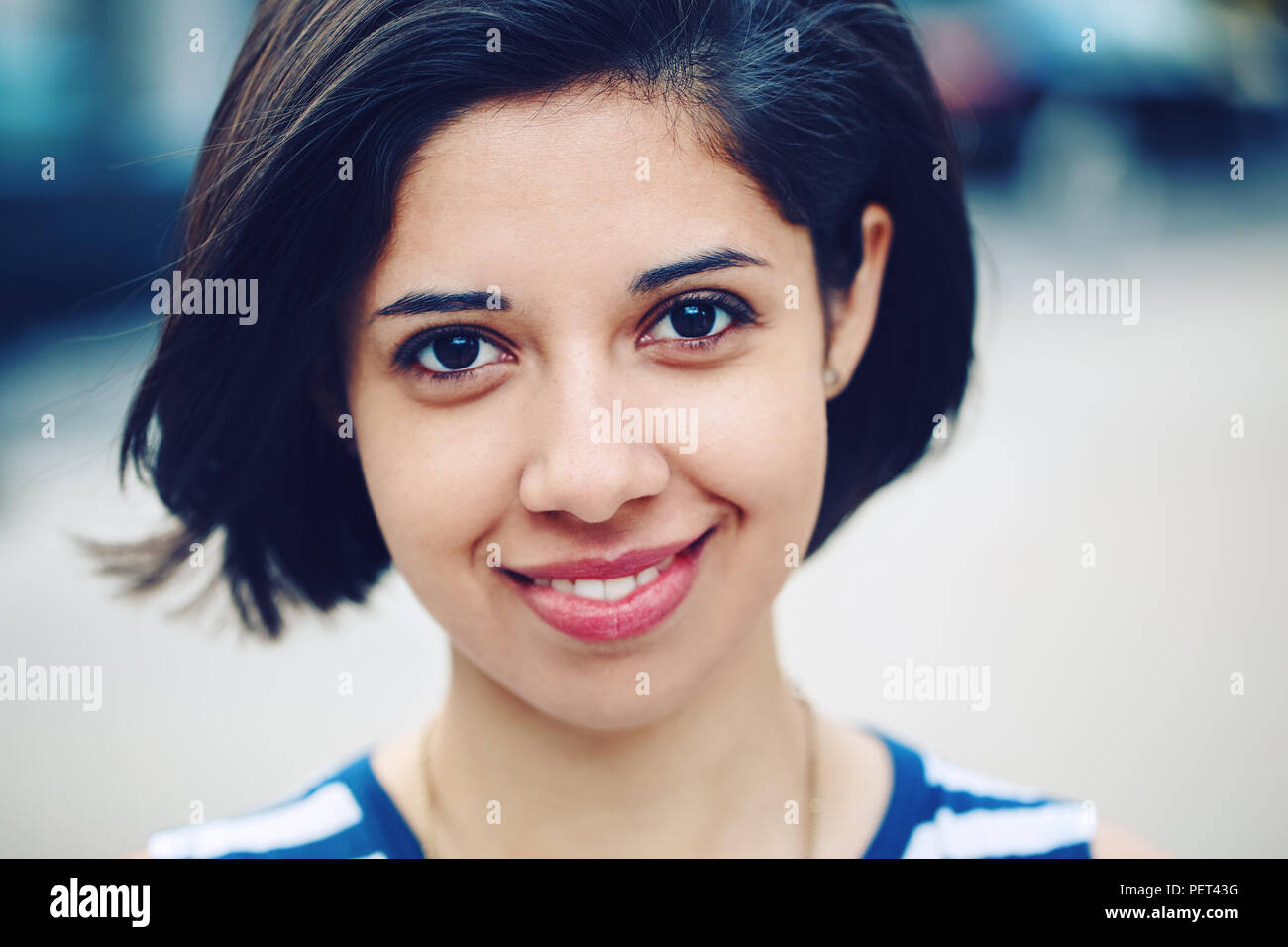 https://c8.alamy.com/comp/PET43G/closeup-portrait-of-beautiful-smiling-young-latin-hispanic-girl-woman-with-short-dark-black-hair-bob-black-eyes-outside-looking-in-camera-toned-wit-PET43G.jpg