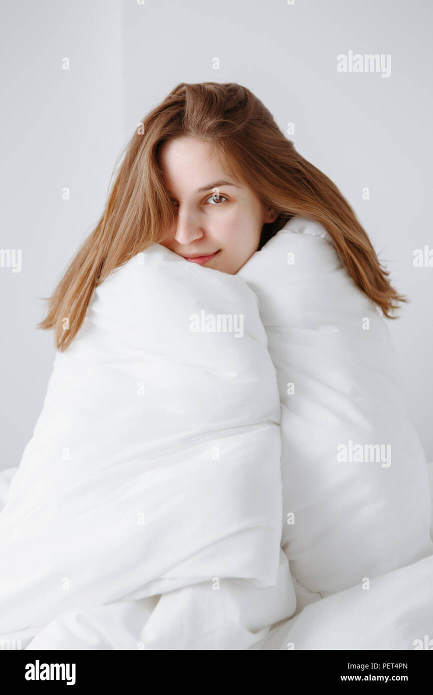 Woman wrapped in blanket bed happy hires stock photography and images