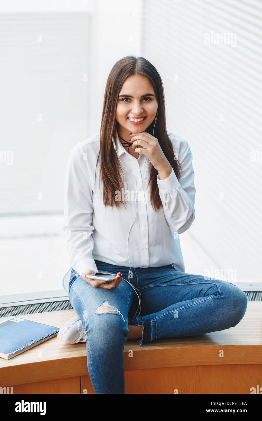 girl in white shirt and blue jeans