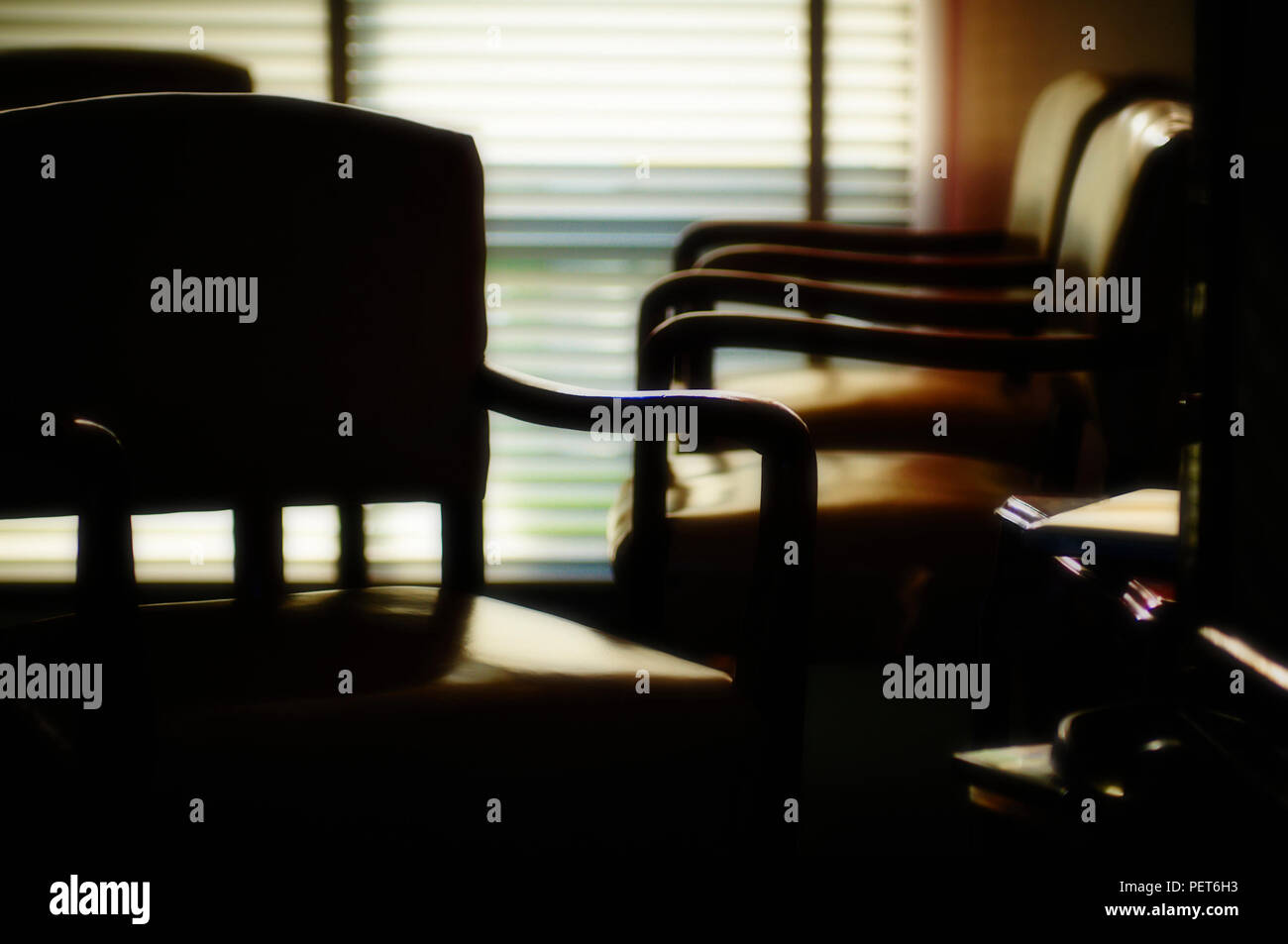 Contrasty shadows and light through blinds at sunset Stock Photo