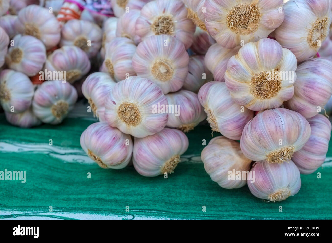 Garlic bulbs for sale on a market stall in Provence, France. Stock Photo