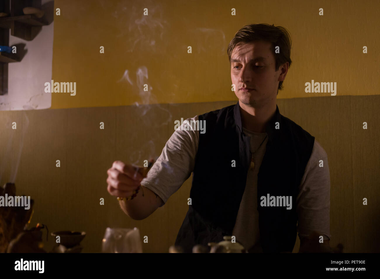 Table with traditional tea setting for chinese tea ceremony. Warm romantic illumination, low key. Relaxation, meditative and chinese culture concept Stock Photo