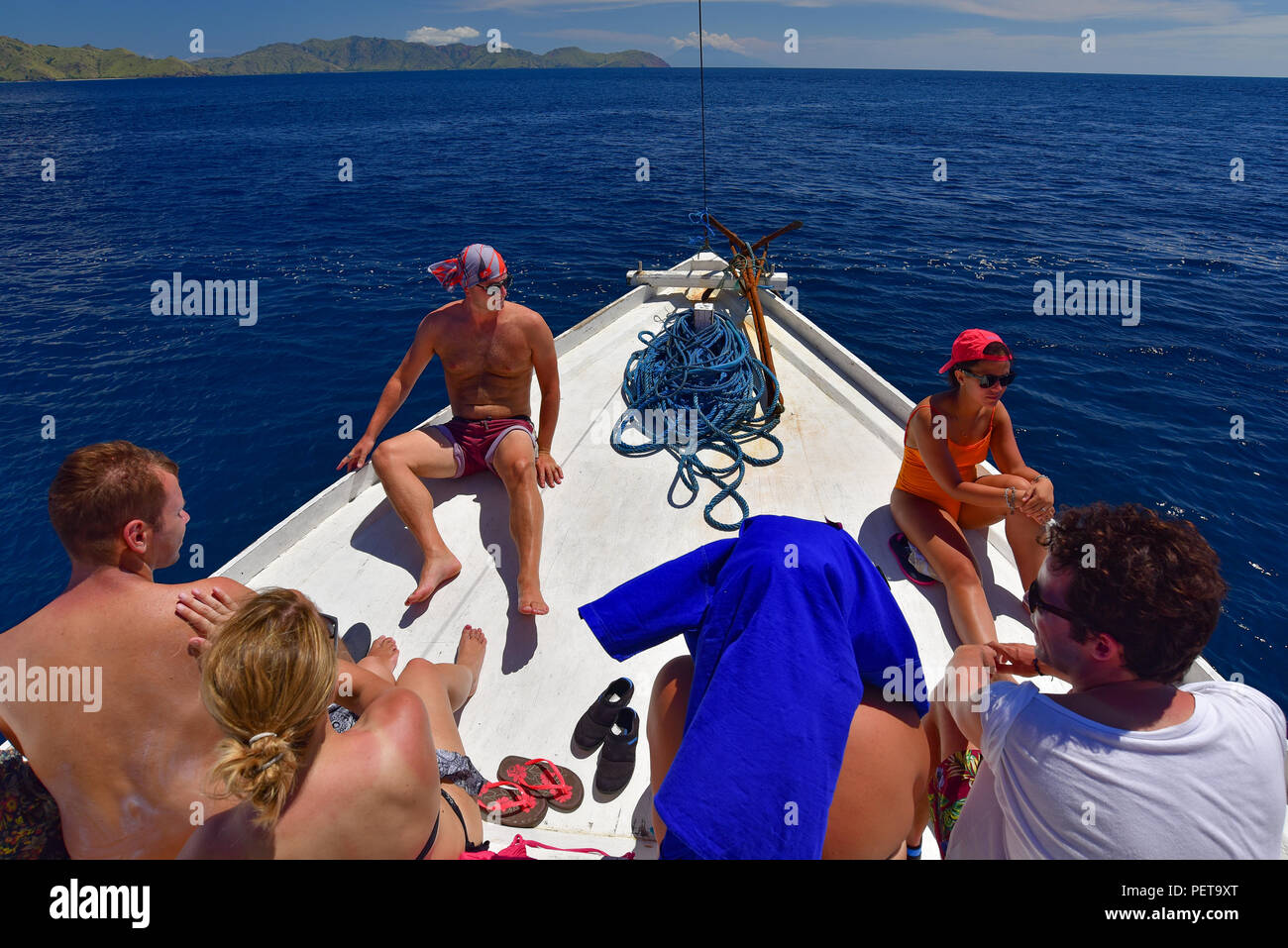 People enjoying sunbath on the deck of a boat on the sea Stock Photo