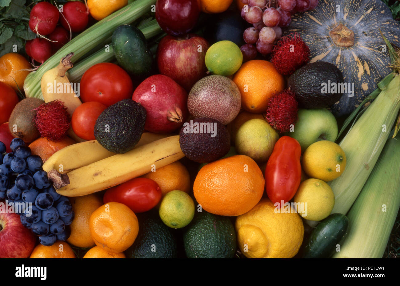 Assorted fresh fruit and vegetables (pomegranates, tomatoes, apples, bananas, grapes, pumpkin, avocados and sweet corn Stock Photo
