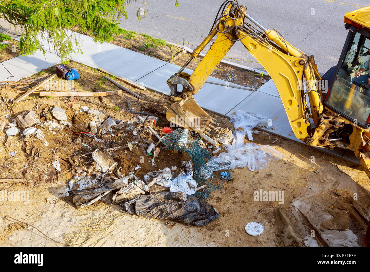 Excavator working on junk dump. Garbage on the city. Soil pollution
