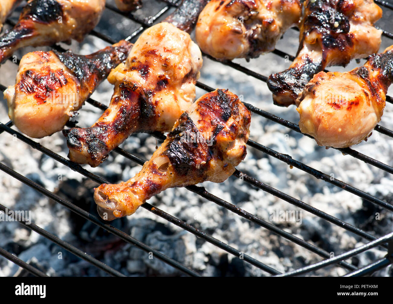 Chicken drumsticks cooking on the grill Stock Photo Alamy