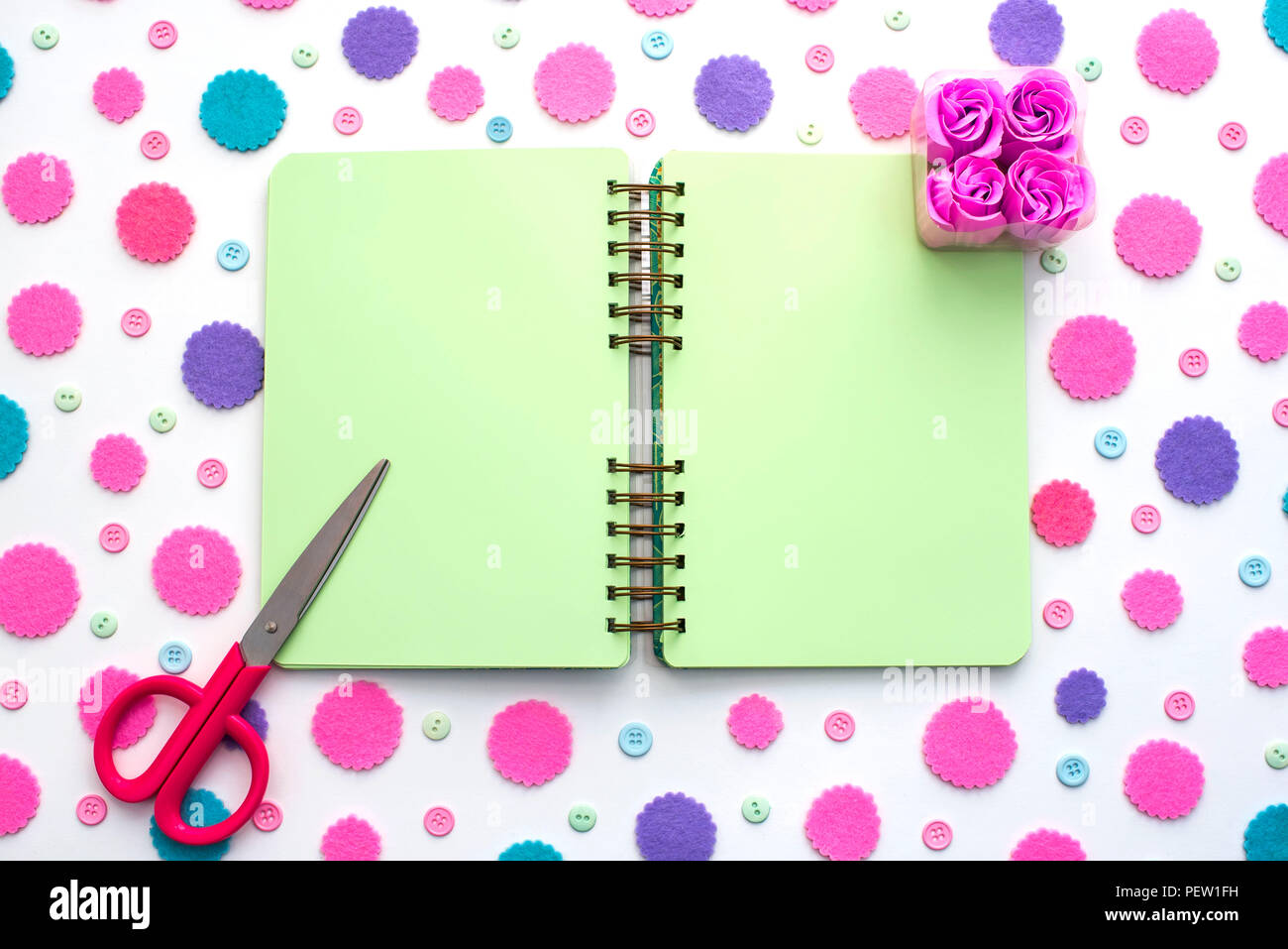 Colored confetti on white background notepad flat lay top view. Festive background copy space tools Stock Photo