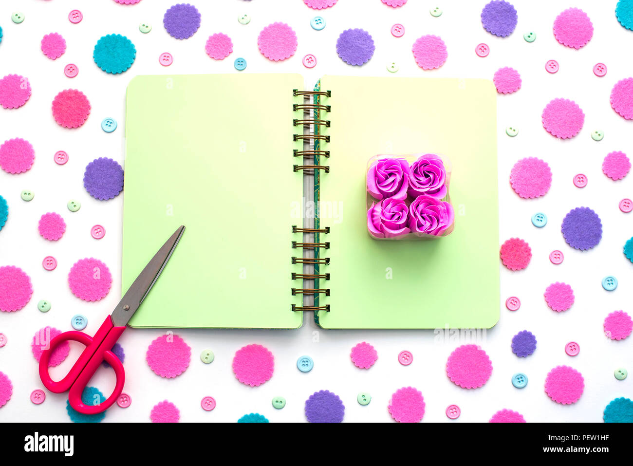 Colored confetti on white background notepad flat lay top view. Festive background copy space tools Stock Photo