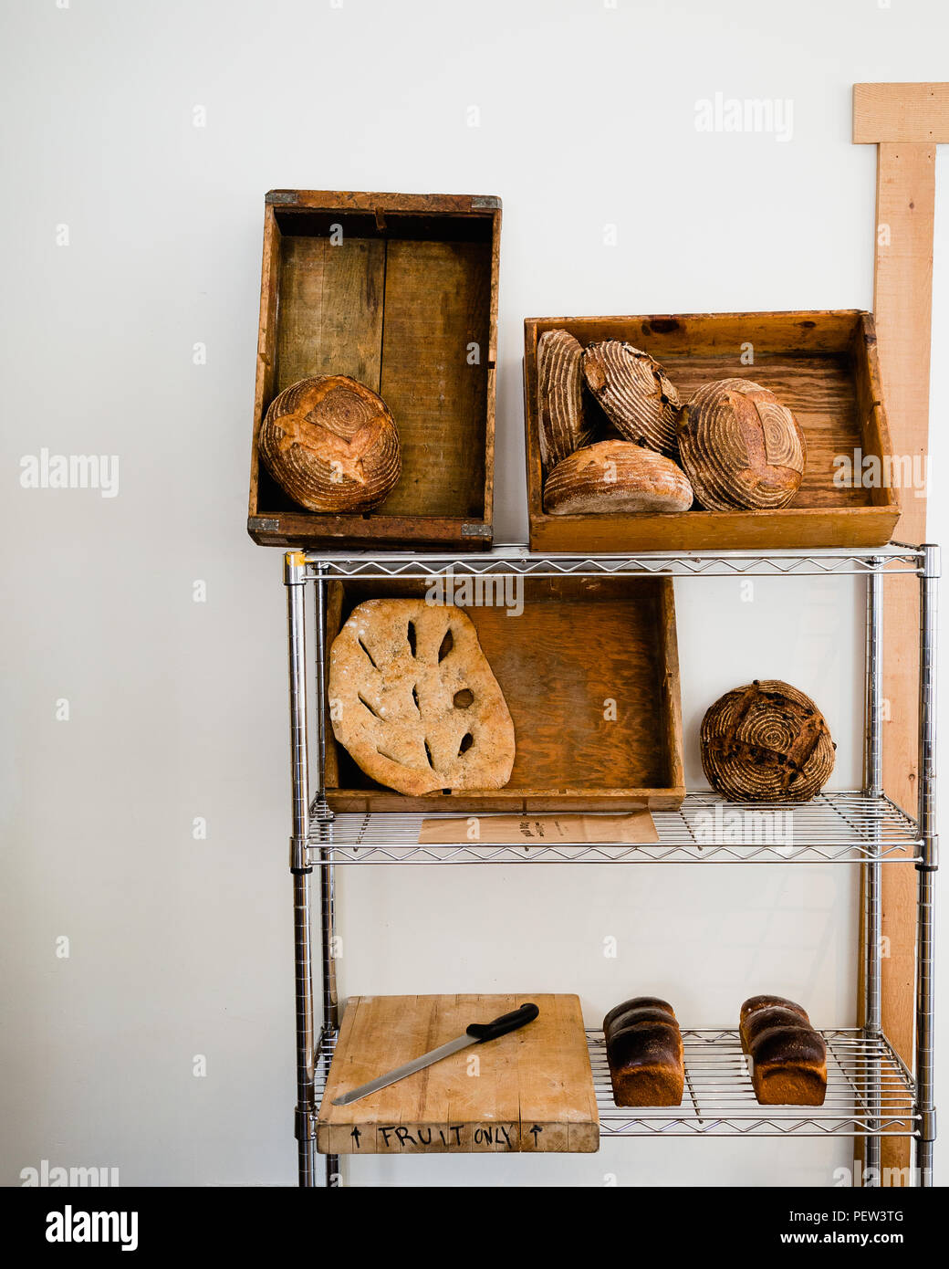 Artisan bread on a shelf against a white wall Stock Photo Alamy