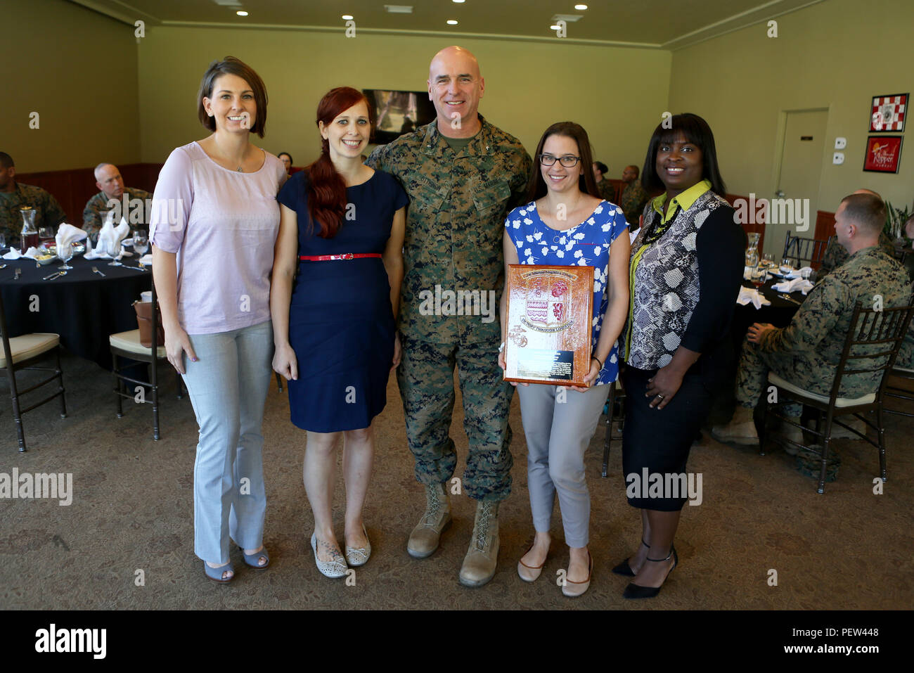 Amanda McMillan, wife of Chief Warrant Officer 2 Christopher McMillan, executive officer for Bulk Fuel Company, 7th Engineer Support Battalion, 1st Marine Logistics Group, winner of the 2015 1st MLG Spouse of the Year stands with Brig. Gen. David A. Ottignon, 1st MLG Commanding General, and the runners- up for the award, aboard Camp Pendleton, Calif., Jan. 28, 2016. Amanda supported Marines and Sailors of the MLG extensively in 2015; assisting in providing more than 100 Thanksgiving dinners to Marines and Sailors, planning and coordinating 12 social events for 7th ESB, and countless other hour Stock Photo