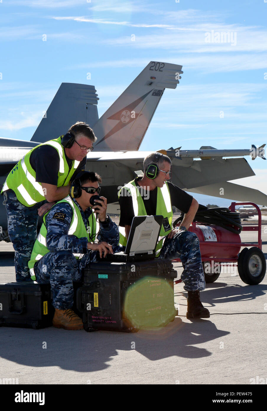 Royal Australian Air Force Aircraft Technician Cpl. Robert Duffy, from No 6  Squadron, Cpl. Kev Johnston and Leading Aircraftman Bruce Foster, from No 1  Squadron, carry out checks on an F/A-18F Super