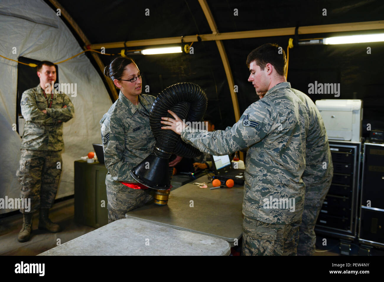 U.S. Air Force Staff Sgt. Faith Olson, a weapons load crew chief assigned  to the 480th Expeditionary Fighter Squadron, returns equipment to U.S. Air  Force Airman 1st Class Galen Eblin, a Support