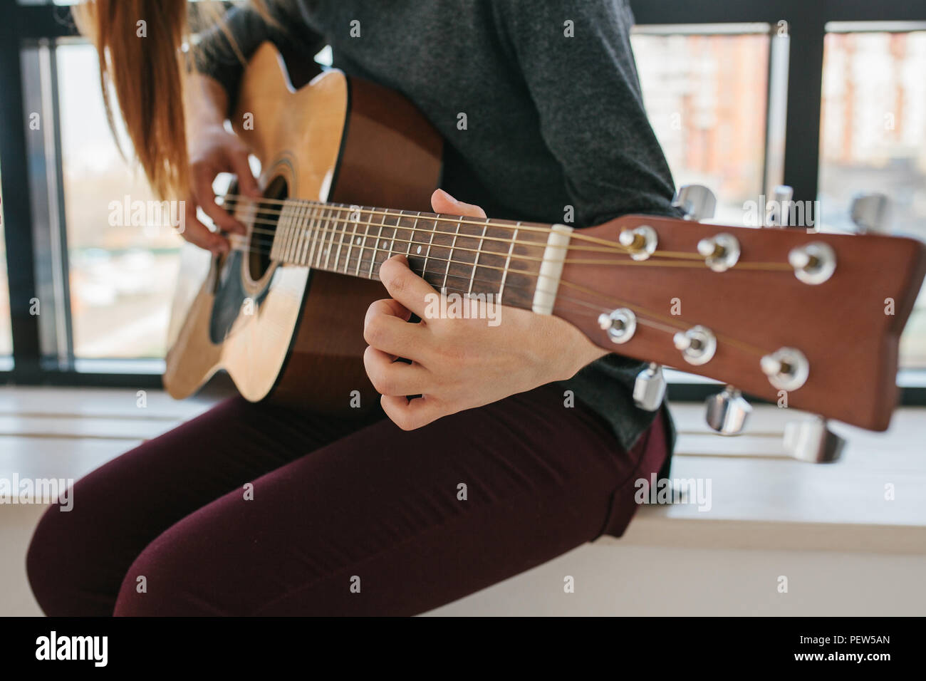 Learning to play the guitar. Music education and extracurricular lessons. Stock Photo