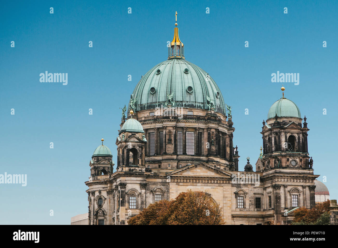 The Berlin Cathedral is called Berliner Dom against the blue sky. Beautiful old building in the style of neoclassicism and baroque with cross and sculptures. Berlin, Germany Stock Photo
