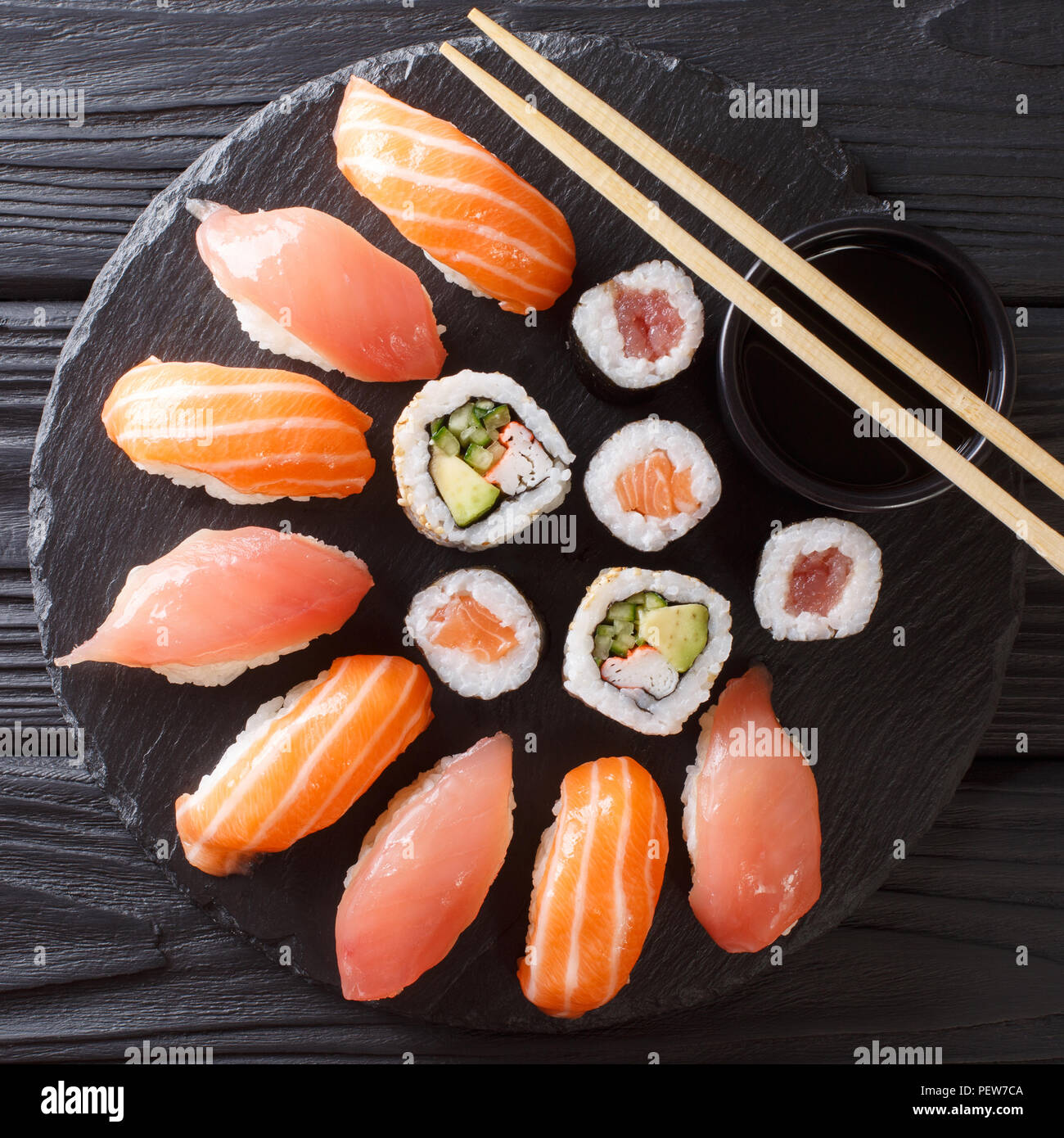 Japanese sushi on a rustic dark background. Sushi rolls, nigiri, maki