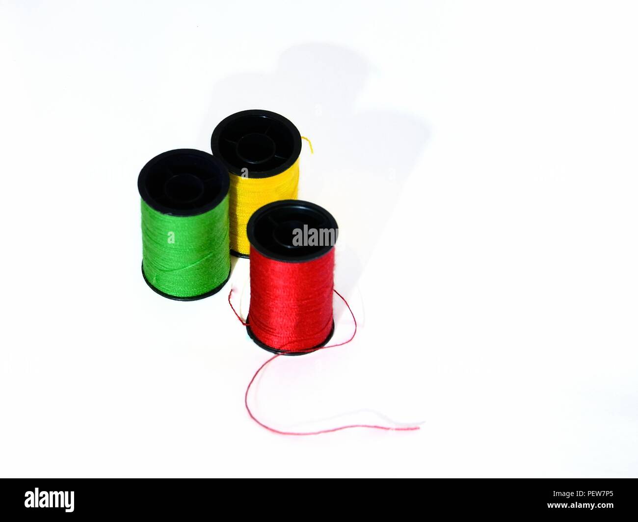 Colorful yarn cotton thread on spool tube on white background Stock Photo