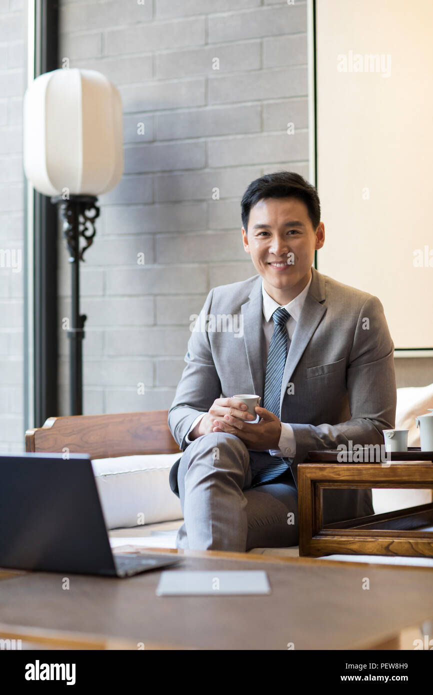 Confident businessman drinking tea Stock Photo