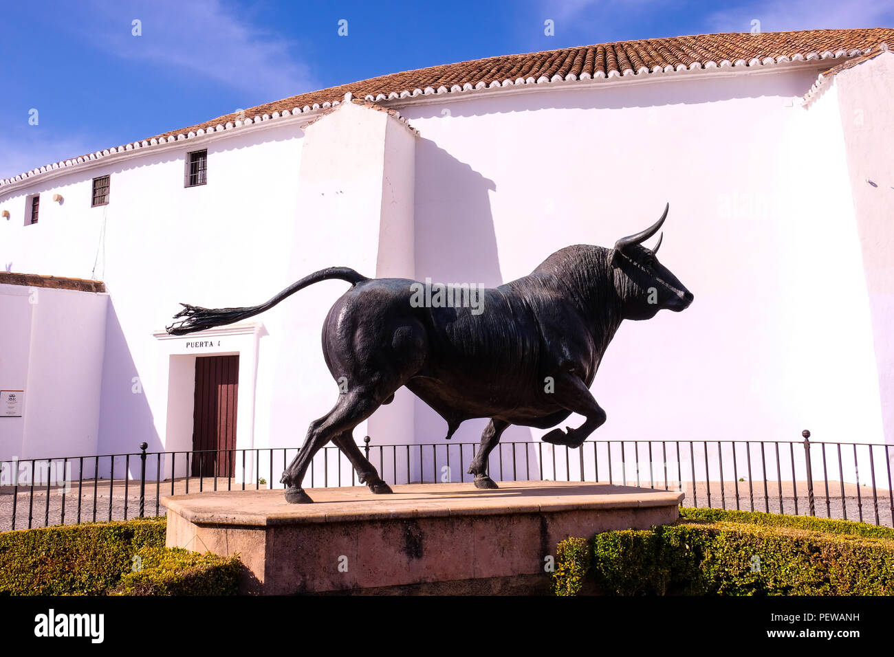 Landscape view of the bullfighting ring of Rondan, in Andalusia, Spain, with the statue of a bull in front of the building Stock Photo