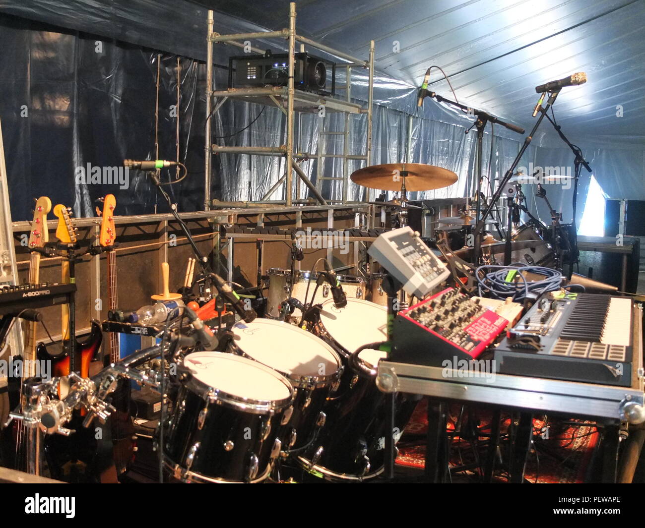 Instruments belong to various bands lined up backstage at a UK rock/folk festival (Green Man, Wales) Stock Photo